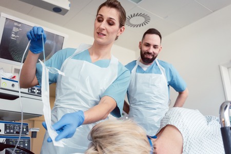 Nurse unpacking gastroscopy tube in hospital preparing for the examination