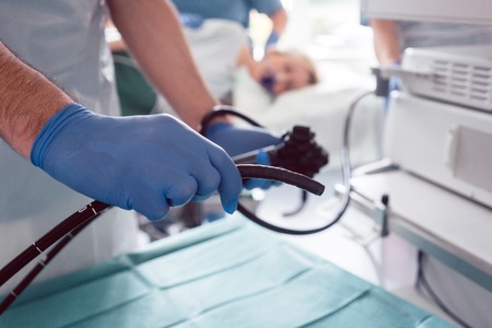 Internist doctors during stomach examination working as a teamの写真素材