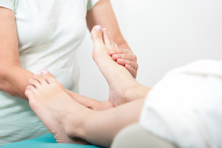 Close-up of a woman receiving foot massage in spaの写真素材
