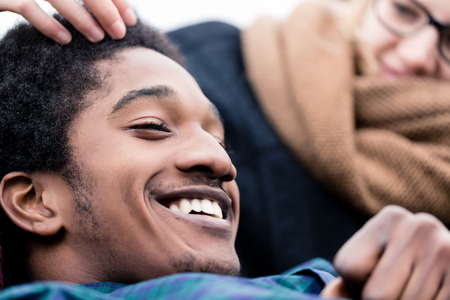 Close-up of smiling african teenage boy with her girlfriendの写真素材