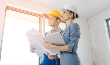 Project owner and construction worker during acceptance checking quality of workの写真素材