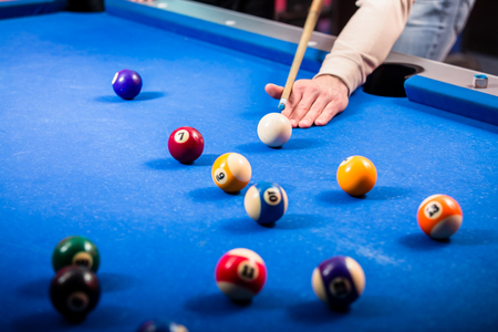 Close-up of a mans hand playing pool