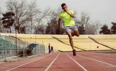 Man running in speed at sport groundの写真素材