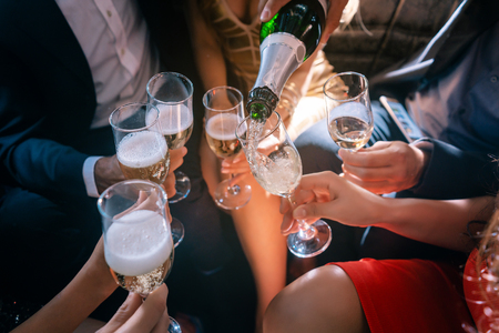 Party people celebrating with champagne, close shotの写真素材