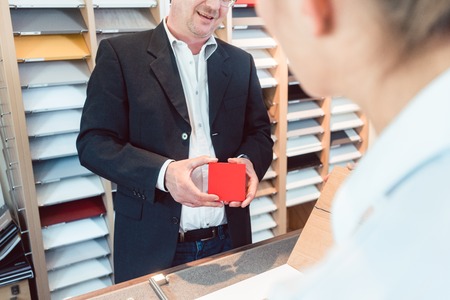 Kitchen expert showing people in his showroom materials, colors and finishingsの写真素材