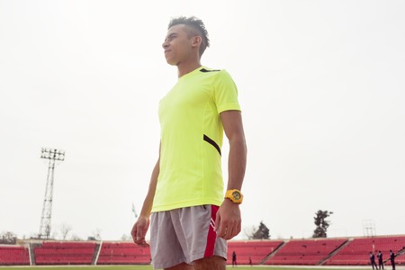 Portrait of a young sportsperson standing on ground