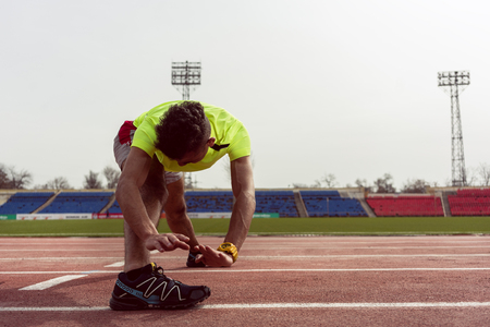Healthy fit man stretching his body during exerciseの写真素材