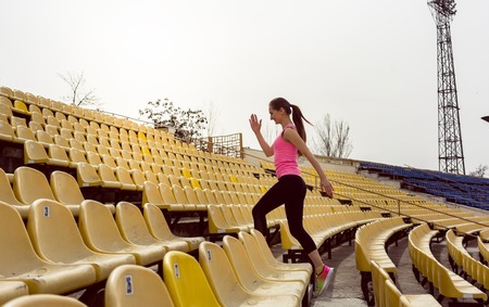 Side view of young woman running on staircase