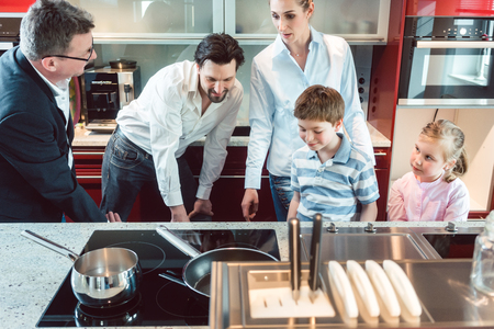 Family shopping for a new kitchen looking at detailsの写真素材