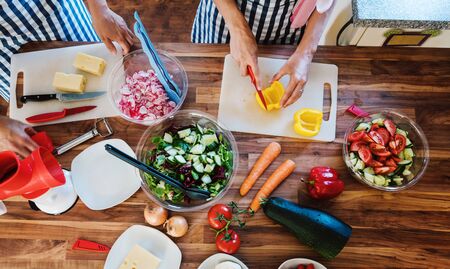 Women preparing salads in the kitchen, high angleの写真素材