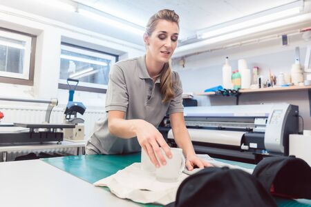 Woman putting promotional items in a set to ship it to the customer