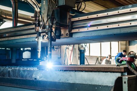 Plasma cutter in a factory cutting thick piece of metalの写真素材