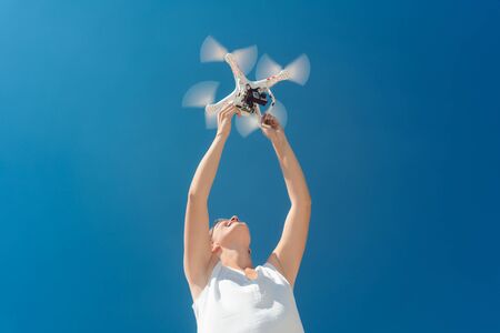 Woman starting a drone for a video production from her hands