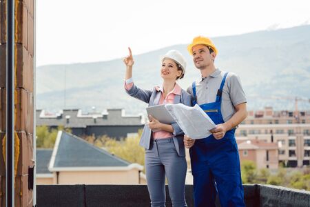 Architect and builder developing ideas for construction project at site