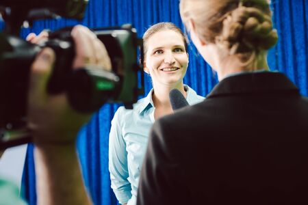 Reporter in an interview with a celebrity asking questionsの写真素材