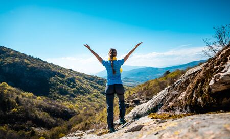 Hiking woman enjoying the freedom of a mountainous landscape near Serres, Greece