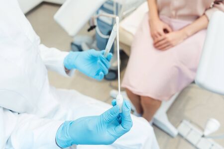 Close-up of woman having test for sexually transmitted disease with doctor