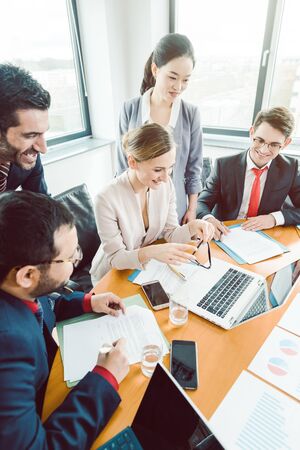 Five business people in a project meeting working togetherの写真素材