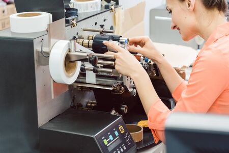 Close-up of Woman working on label printing machine