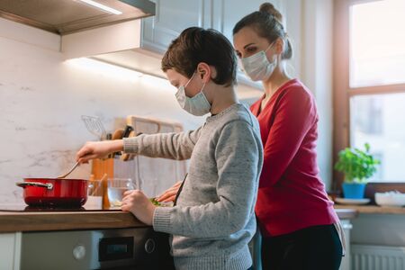 Family cooking at home in kitchen during coronavirus crisisの写真素材
