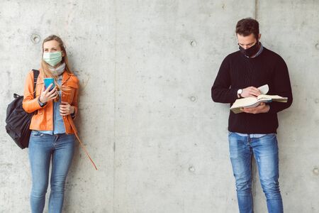 Social distancing on university campus during coronavirus crisis, space between studentsの写真素材