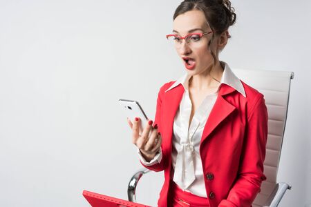 Businesswoman receiving bad news on the phone in her handの写真素材