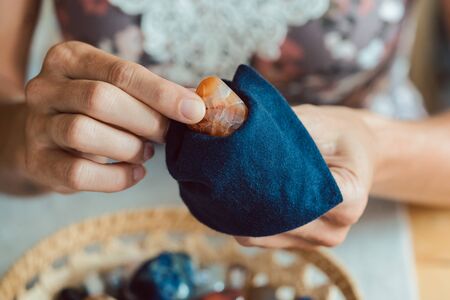 Woman dusting her mineral collectionの写真素材