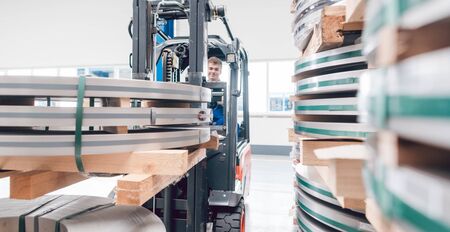 Worker transporting metal material from warehouse to production, close-upの写真素材