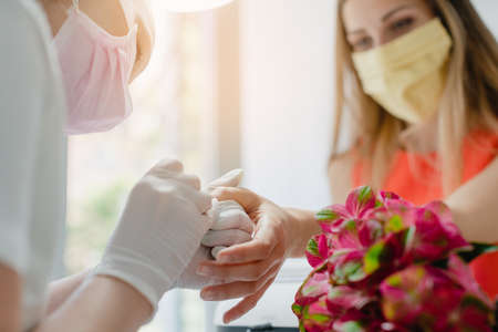 Manicure in nail parlor during covid-19 getting a manicure