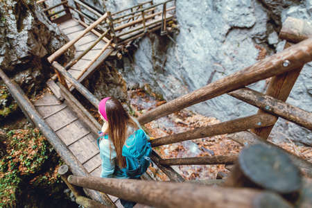 Woman hiking a gorge in the mountains during fall