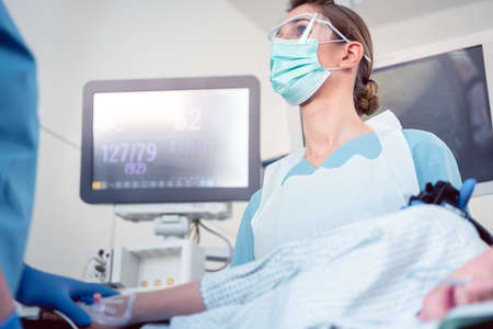 Doctor during colonoscopy in hospital looking at screen at picture from endoscope