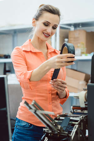 Worker at Quality control in the label printing shopの写真素材