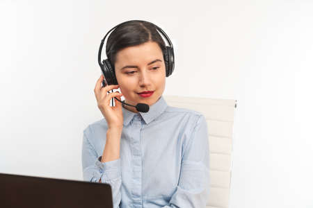 Portrait of a businesswoman working with headphone and laptopの写真素材