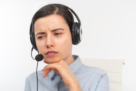 Front view of a business woman with headphoneの写真素材