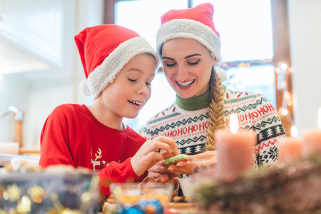 Family having fun baking cookies for Christmas in their kitchenの写真素材