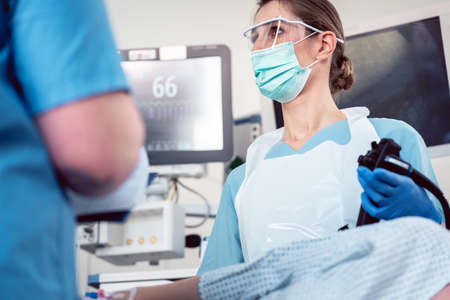 Internal specialist doctor operating endoscope in colonoscopy procedureの写真素材