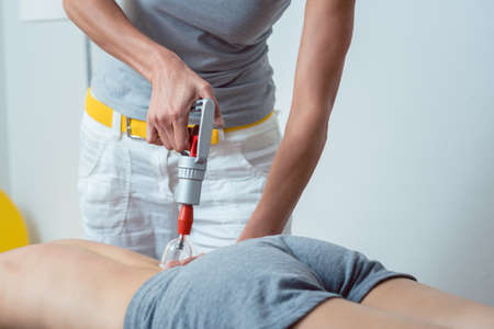 Session in the physical therapy with cupping on a woman patientの写真素材