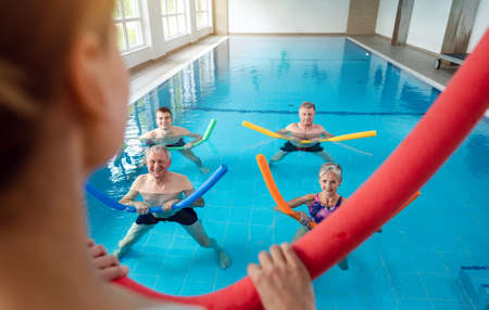 People in aqua fitness class during a physical therapy session in a physiotherapy centerの写真素材