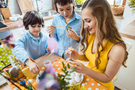 Mother and sons coloring eggs for the Easter holidaysの写真素材