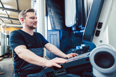 Machine operator programming modern industrial cnc latheの写真素材