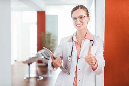 Doctor woman in her practice giving a thumbs upの写真素材
