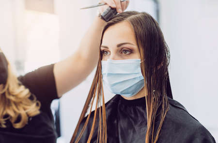 Hairdresser and customer during virus pandemicの写真素材