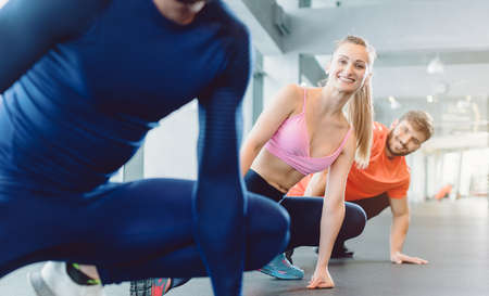 Group of people in gym fitness class stretching