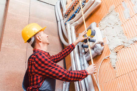 Male engineer installing the pipesの写真素材