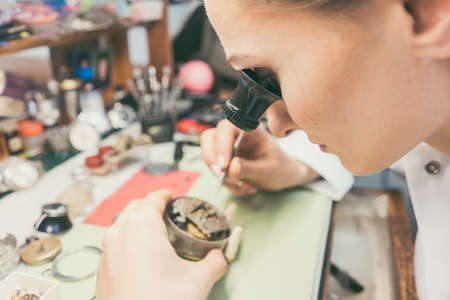 Watchmaker absorbed in her delicate work