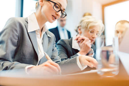 Business people in meeting room working togetherの写真素材