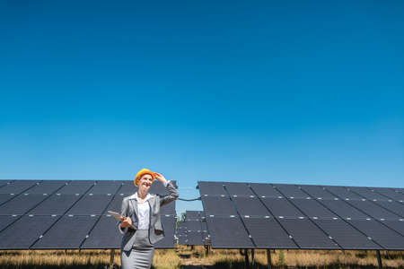 Business woman or investor inspecting her solar farm