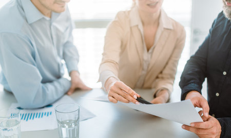 Business people discussing figures in a meetingの写真素材