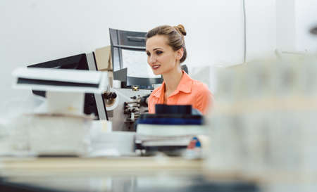 Woman in printing shop on the design computer