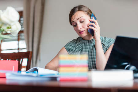 Businesswoman cannot tolerate working from home any longerの写真素材